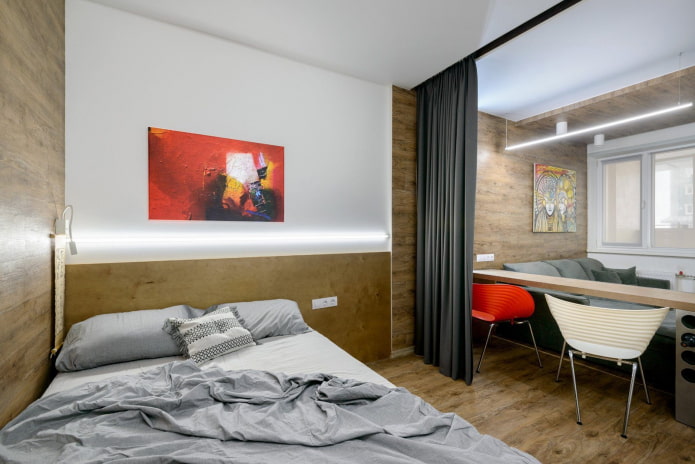 cama e sofá em apartamento de um cômodo