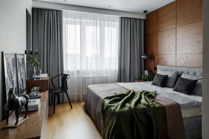 cabeceira marrom com cortinas cinza e uma cama